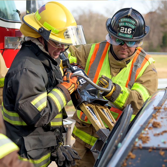 Two people working with emergency equipment Two people working with emergency equipment