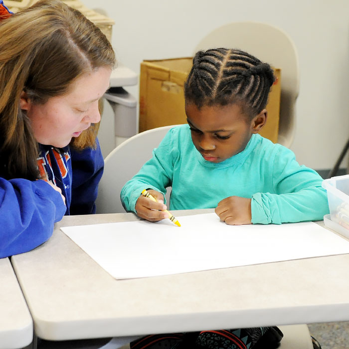 A child writing at a desk